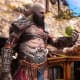 Kratos stares at an Idunn Apple from a Nornir Chest in God of War Ragnarok.